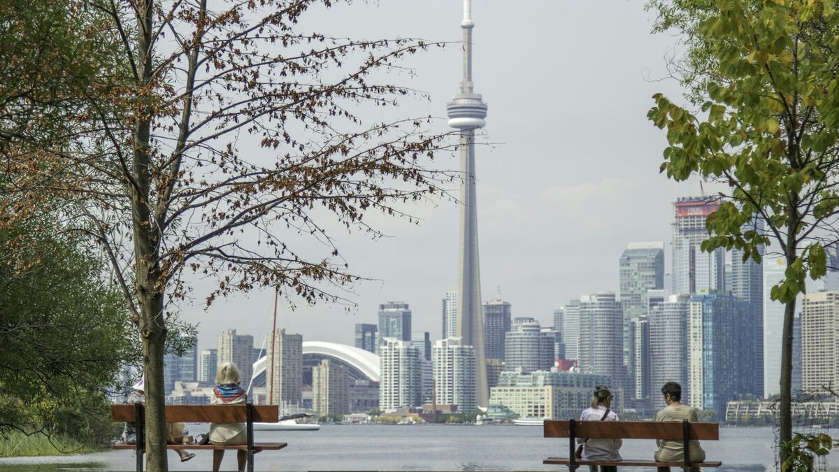 Express Entry Canada: how the system works and how to build a strong profile Person preparing their Express Entry Canada file at a computer surrounded by documents