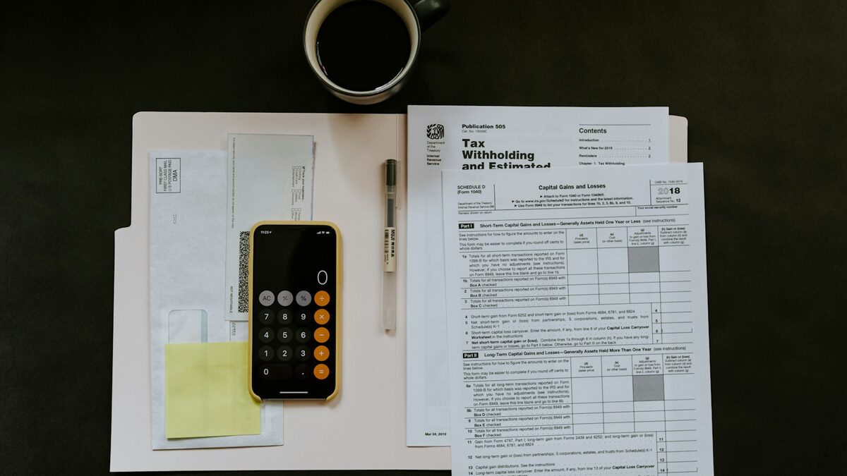 Immigration Application Mistakes: The Guide to Avoiding Every One of Them Focused person reviewing immigration forms spread across a kitchen table, with a passport and a highlighter within reach